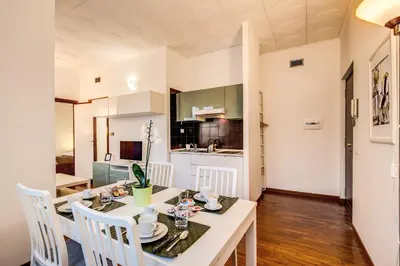 a kitchen and dining room with a table and chairs at M&L Apartments - Ardesia Colosseo in Rome