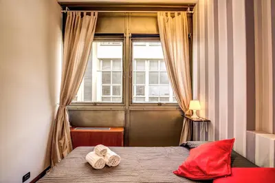 a bedroom with a bed and a window with towels on it at M&L Apartments - Ardesia Colosseo in Rome