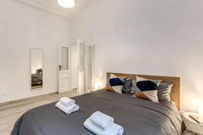 a bedroom with a large bed with towels on it at Supernova Apartment Trastevere in Rome