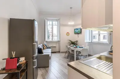a kitchen and a living room with a refrigerator at Supernova Apartment Trastevere in Rome
