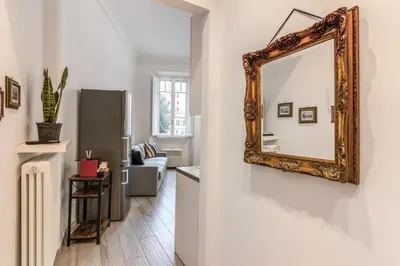 a mirror hanging on a wall in a living room at Supernova Apartment Trastevere in Rome