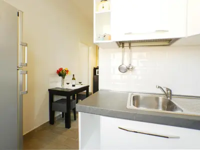 a kitchen with a sink and a table at Movie Apartment in Rome