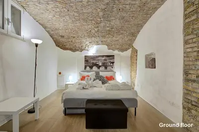 a bedroom with a bed and a brick wall at Casa a Monti in Rome