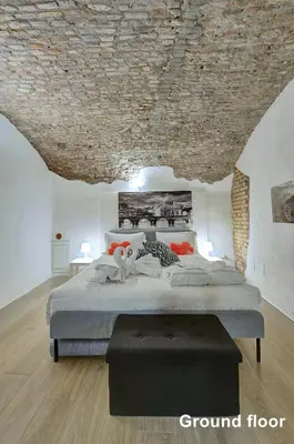 a bedroom with a large bed with a stone ceiling at Casa a Monti in Rome