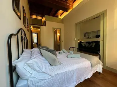 a bed with white sheets and pillows in a bedroom at Boutique Signature Suite in the Heart of Ancient Rome in Rome