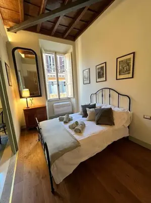 a bedroom with a bed with a teddy bear on it at Boutique Signature Suite in the Heart of Ancient Rome in Rome