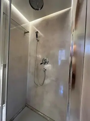 a shower in a bathroom with a shower head at Boutique Signature Suite in the Heart of Ancient Rome in Rome