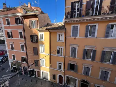 a group of buildings with windows on a street at Boutique Signature Suite in the Heart of Ancient Rome in Rome