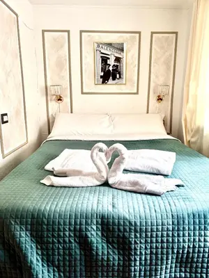 a bed with two swans made out of towels at PARIOLI LUXURY SUITE III in Rome