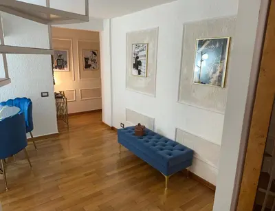 a living room with a blue couch and a wall at PARIOLI LUXURY SUITE III in Rome
