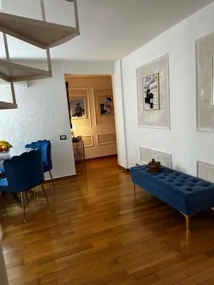 a living room with a blue couch and a table at PARIOLI LUXURY SUITE III in Rome
