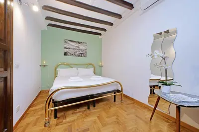 a small room with a bed and a table at La Civetta a Navona in Rome
