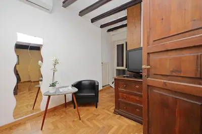 a room with a door and a chair and a table at La Civetta a Navona in Rome