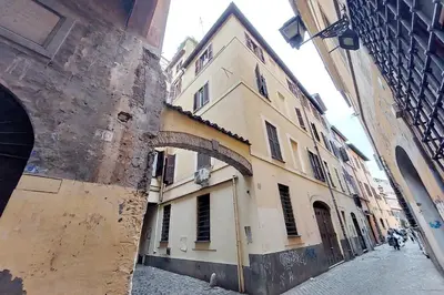 an alley in a city with an old building at La Civetta a Navona in Rome
