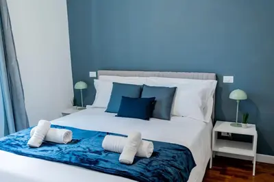 a bedroom with a large white bed with two pillows at Domina Apartments Roma - San Pietro 1 in Rome