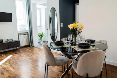 a dining room with a glass table and chairs at Domina Apartments Roma - San Pietro 1 in Rome