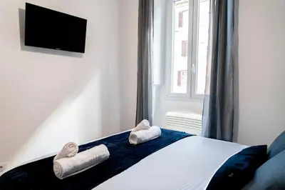 a bedroom with a bed with towels on it at Domina Apartments Roma - San Pietro 1 in Rome