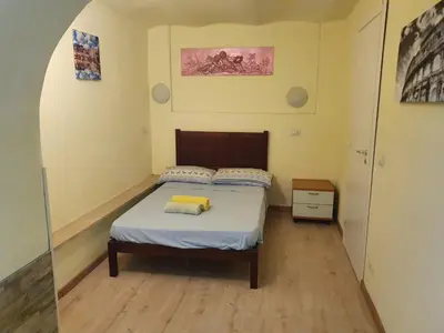 a small bedroom with a bed and a mirror at Holiday City Center in Rome