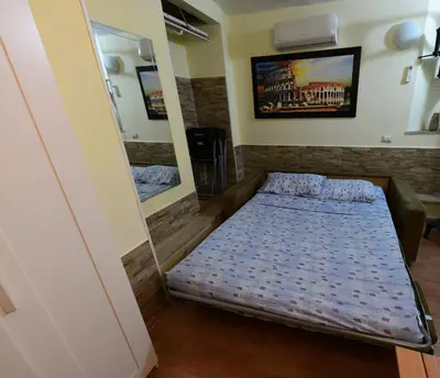 a bed in a room with a mirror at Holiday City Center in Rome