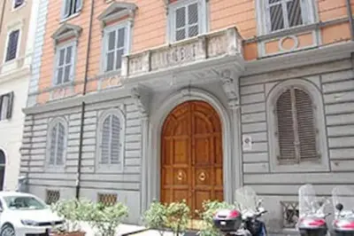 a building with a wooden door in front of a building at Holiday City Center in Rome