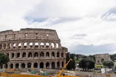 a building is under construction in front of the coliseum at Welcome to the ColosseHome in Rome