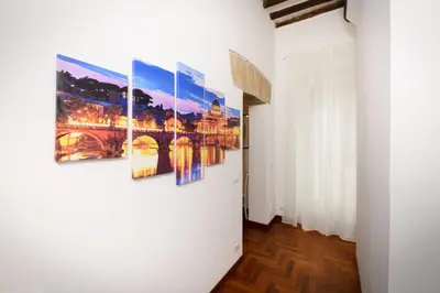 a group of paintings on a wall in a room at Mommy's - Vatican House in Rome