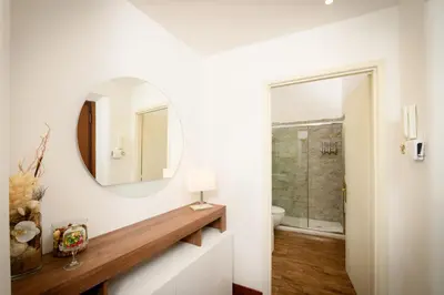 a white bathroom with a mirror and a toilet at Mommy's - Vatican House in Rome
