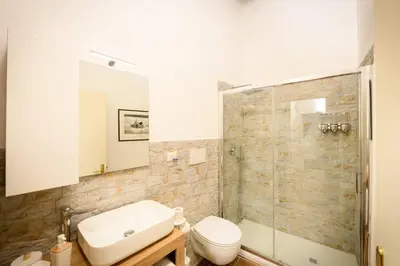 a bathroom with a sink and a toilet and a shower at Mommy's - Vatican House in Rome