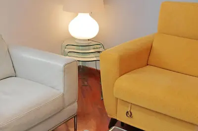 a living room with two chairs and a lamp at YCH-Una finestra sulla Cupola di San Pietro in Rome