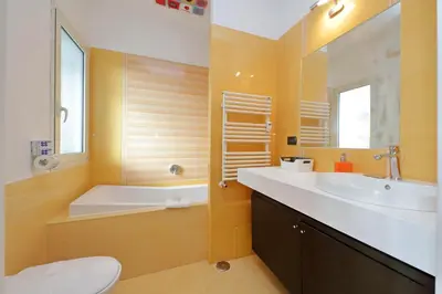 a bathroom with a tub and a sink and a toilet at YCH-Una finestra sulla Cupola di San Pietro in Rome