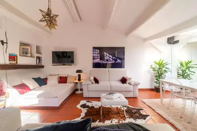 a living room with two white couches and a table at Campo de' Fiori Enchanting Attic in Rome