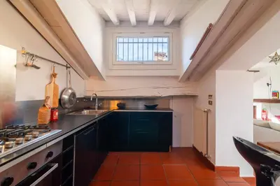 a kitchen with a sink and a window at Campo de' Fiori Enchanting Attic in Rome