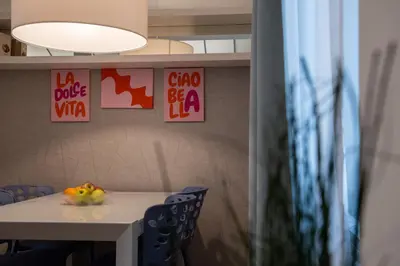 a table with chairs and a bowl of fruit on it at COLOSSEUM VIEW ACCOMODATION in Rome