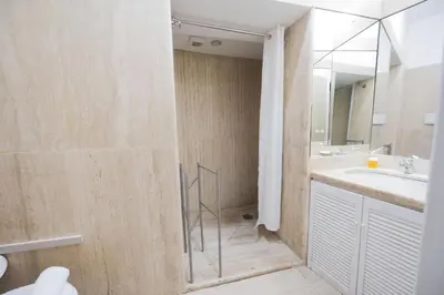 a bathroom with a shower and a sink and a mirror at Via Giulia Charming Apartment with Balcony in Rome