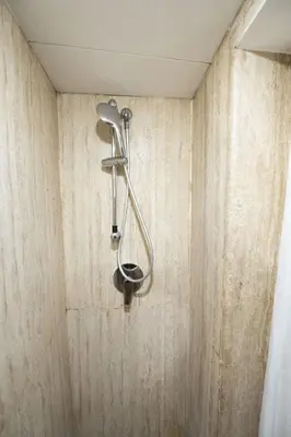 a shower with a shower head on a wall at Via Giulia Charming Apartment with Balcony in Rome
