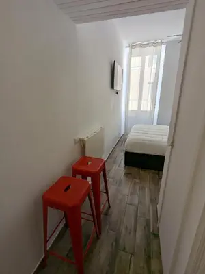 a room with two red tables and a bed at Borgo Place in Rome