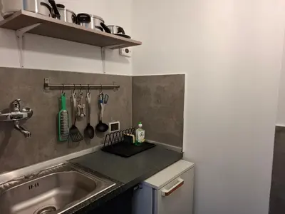 a kitchen with a sink and a counter with utensils at Borgo Place in Rome