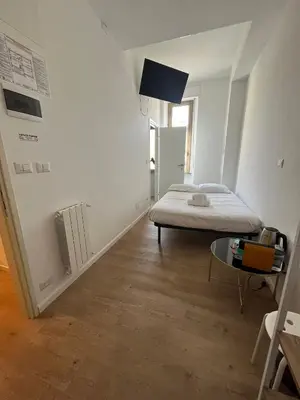 a bedroom with a bed and a table in it at Camera singola con vista su San Pietro in Rome