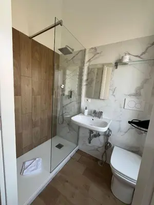 a bathroom with a shower and a toilet and a sink at Camera singola con vista su San Pietro in Rome