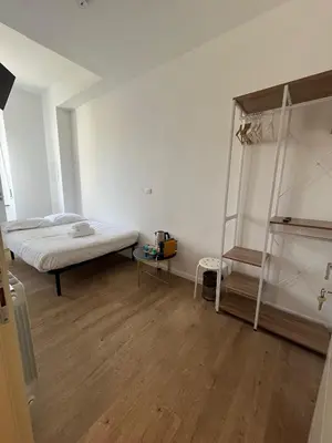 a white room with a bed and a ladder at Camera singola con vista su San Pietro in Rome