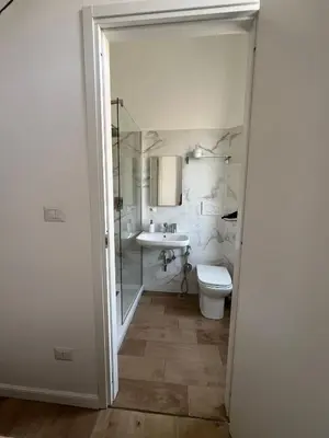 a bathroom with a toilet and a sink at Camera singola con vista su San Pietro in Rome