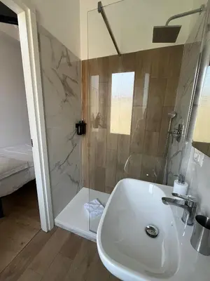 a bathroom with a sink and a shower at Camera singola con vista su San Pietro in Rome