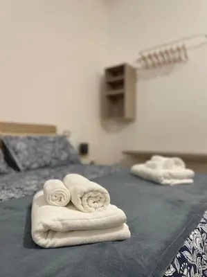 two towels on a bed in a room at ALMA - Vatican Apartment in Rome