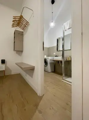 a large white room with a sink and a counter at ALMA - Vatican Apartment in Rome