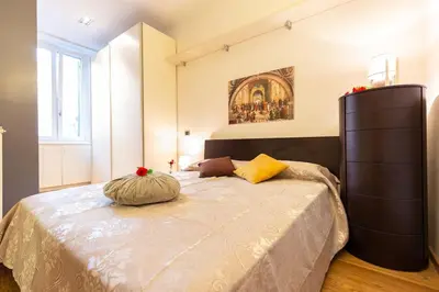 a bedroom with a large bed with a pillow on it at Gioia Romana in Rome