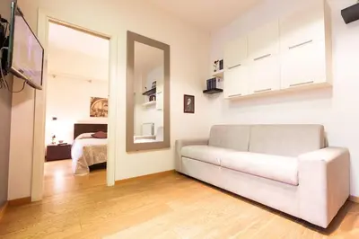 a living room with a couch and a mirror at Gioia Romana in Rome