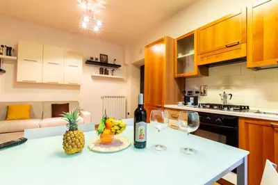 a kitchen with a table with two glasses of wine at Gioia Romana in Rome