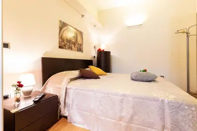 a bedroom with a large bed with a dresser at Gioia Romana in Rome