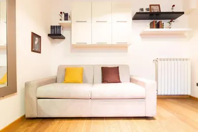 a white couch with two pillows on it in a room at Gioia Romana in Rome