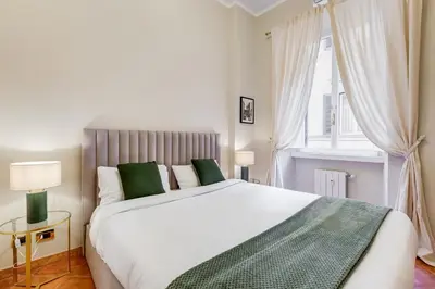 a bedroom with a large white bed and a window at URBANA 18 in Rome